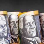 Australian money background.  Fifty dollar notes against dark background.