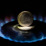 1 euro coin stands on a hot gas burner