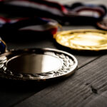 Gold and silver bronze medal on wooden table