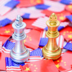 Two king chess games on US and Chinese flags indicate a trade war and trade tensions, a confrontation between two major countries in which the US imposes high tariff rates on Chinese exports.