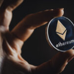 Silver Ethereum cryptocurrency in a hand
