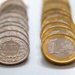 Euro and Swiss Franc coins.
