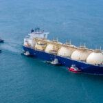LNG (Liquified Natural Gas) tanker anchored in Gas terminal gas tanks for storage. Oil Crude Gas Tanker Ship. LPG at Tanker Bay Petroleum Chemical or Methane freighter export import transportation